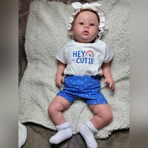 Adorable Baby Doll with Blue Shorts